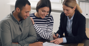 (a couple reviewing their debt settlement agreement with their lawyer)