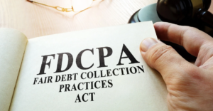A close-up image of a hand holding a booklet titled “FDCPA Fair Debt Collection Practices Act,” symbolizing consumer protection laws against unfair debt collection practices. Ideal for legal, financial, or debt-related content.