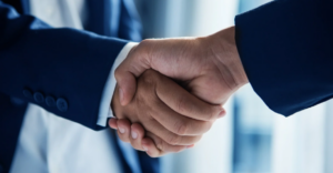 (Professional deal-making captured in a firm handshake between two individuals in formal business attire, symbolizing trust, agreement, and successful negotiation.)